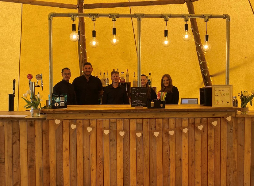 The Distillery Box team tending the bar.
